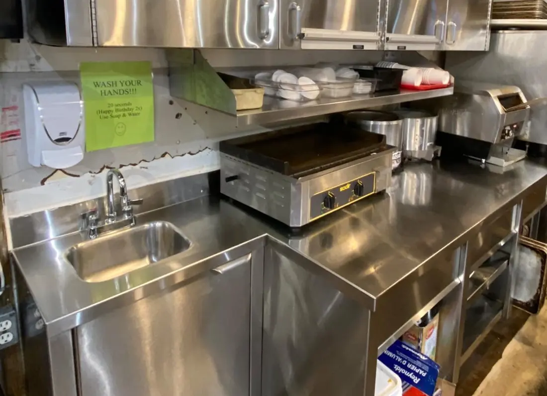 Clean stainless-steel surfaces in a commercial kitchen