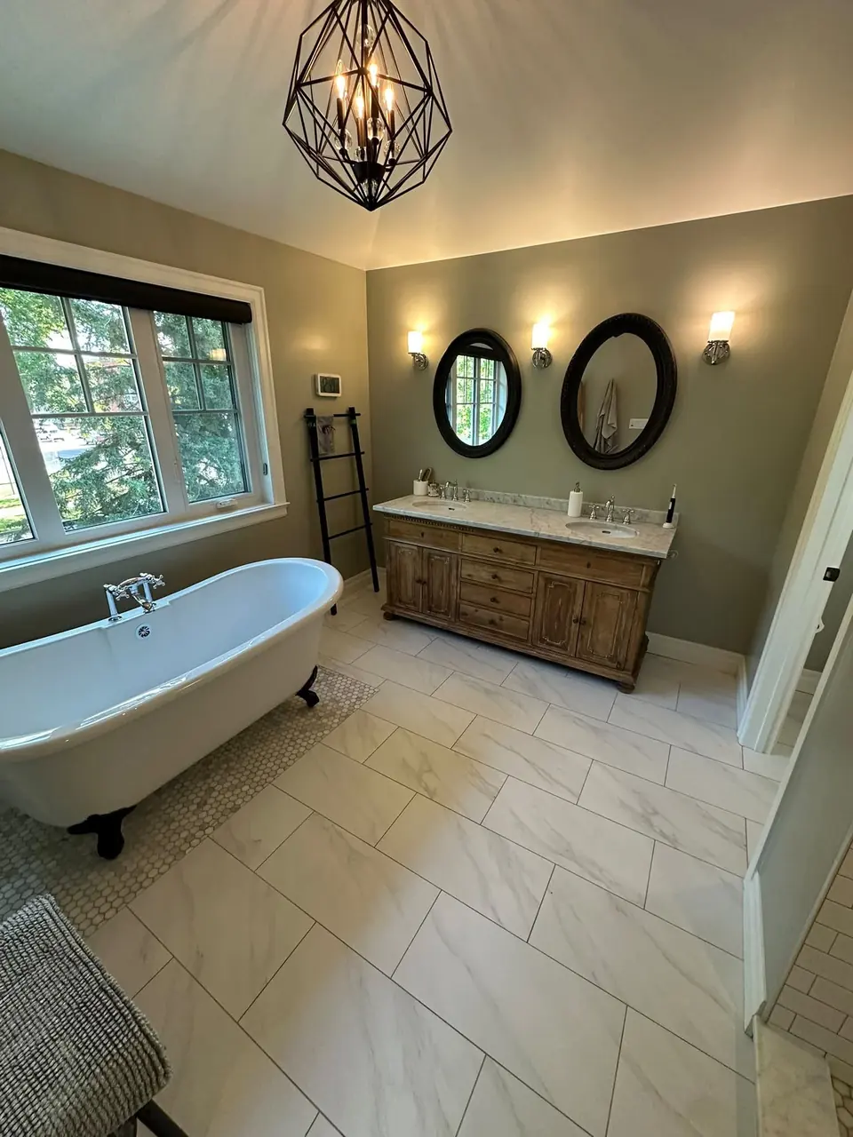 Cleaned bathroom with a freestanding tub, double vanity and tiled floor