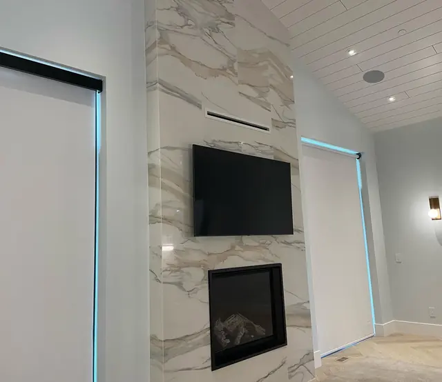 Clean empty room with a marble fireplace wall