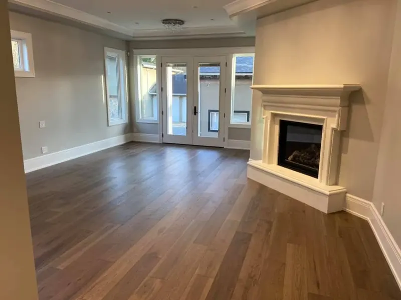 Clean room with a fireplace and hardwood floors