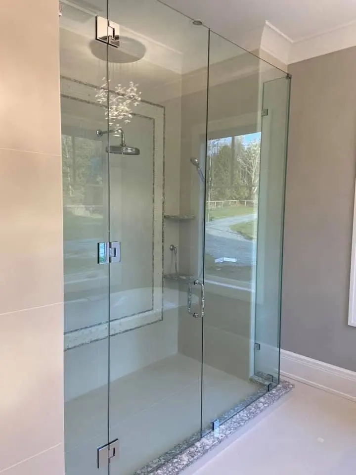 Clean glass shower enclosure in a finished bathroom