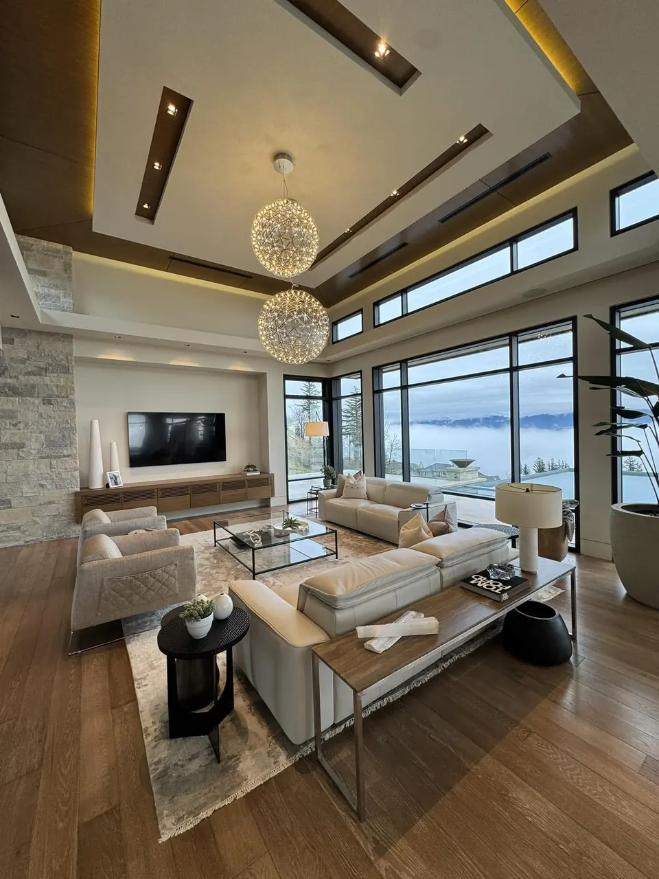 Clean, bright living room with large windows and sofas